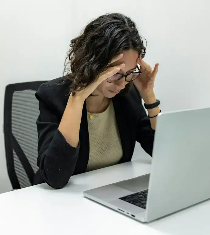a woman sitting in front of a laptop computer